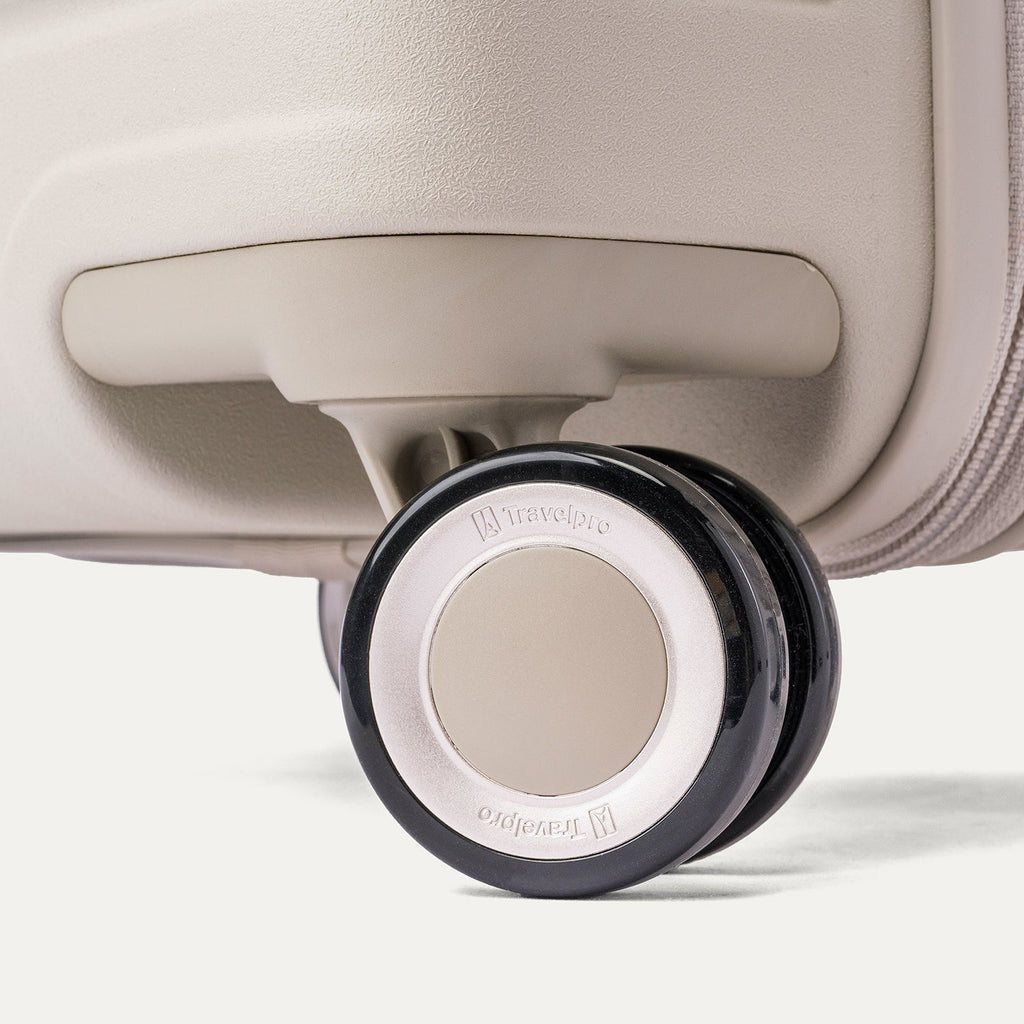 Close-up of a MagnaTrac self-aligning spinner wheel on the Travelpro Platinum Reserve Medium Check-In Hardside Spinner in Sandstone