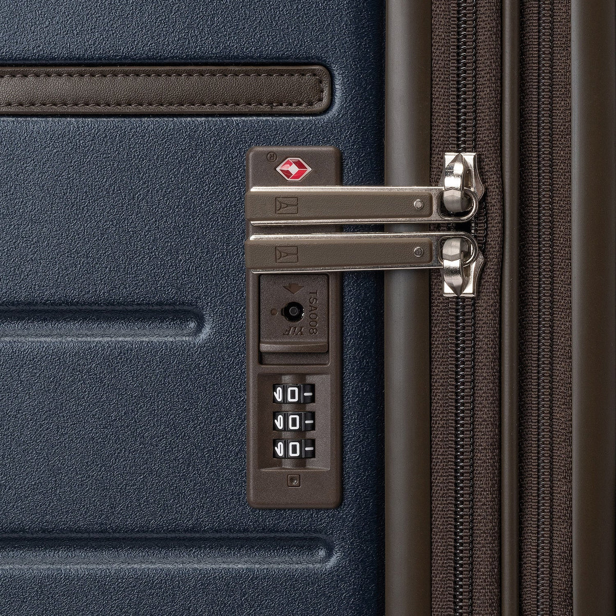 Close-up of the built-in TSA lock on the Travelpro Platinum Reserve Medium Check-In Hardside Spinner in Midnight Trail