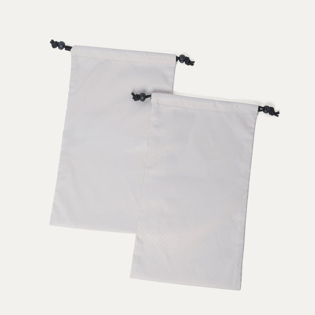 Removable drawstring shoe bags included with the Travelpro Platinum Reserve Medium Check-In Hardside Spinner in Midnight Trail