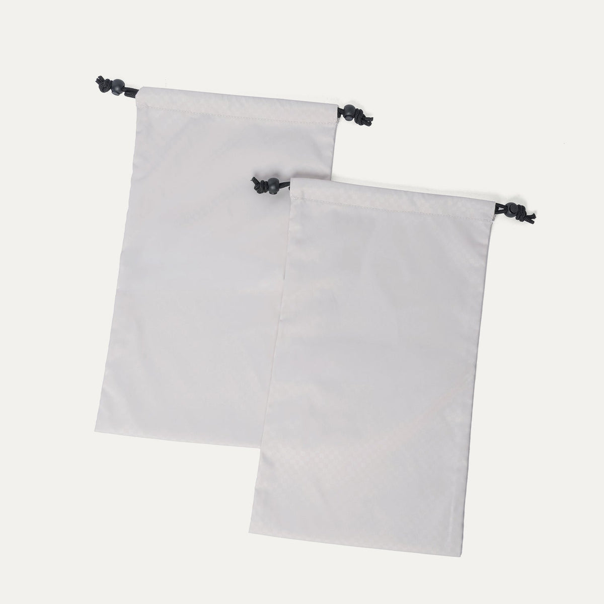 Removable drawstring shoe bags included with the Travelpro Platinum Reserve Medium Check-In Hardside Spinner in Midnight Trail