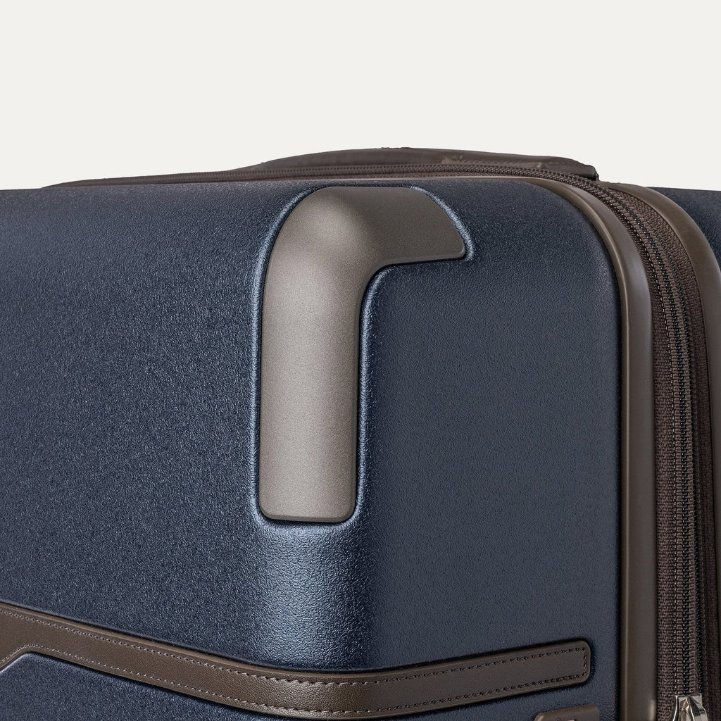Close-up of the zinc corner armour on the Travelpro Platinum Reserve Medium Check-In Hardside Spinner in Midnight Trail