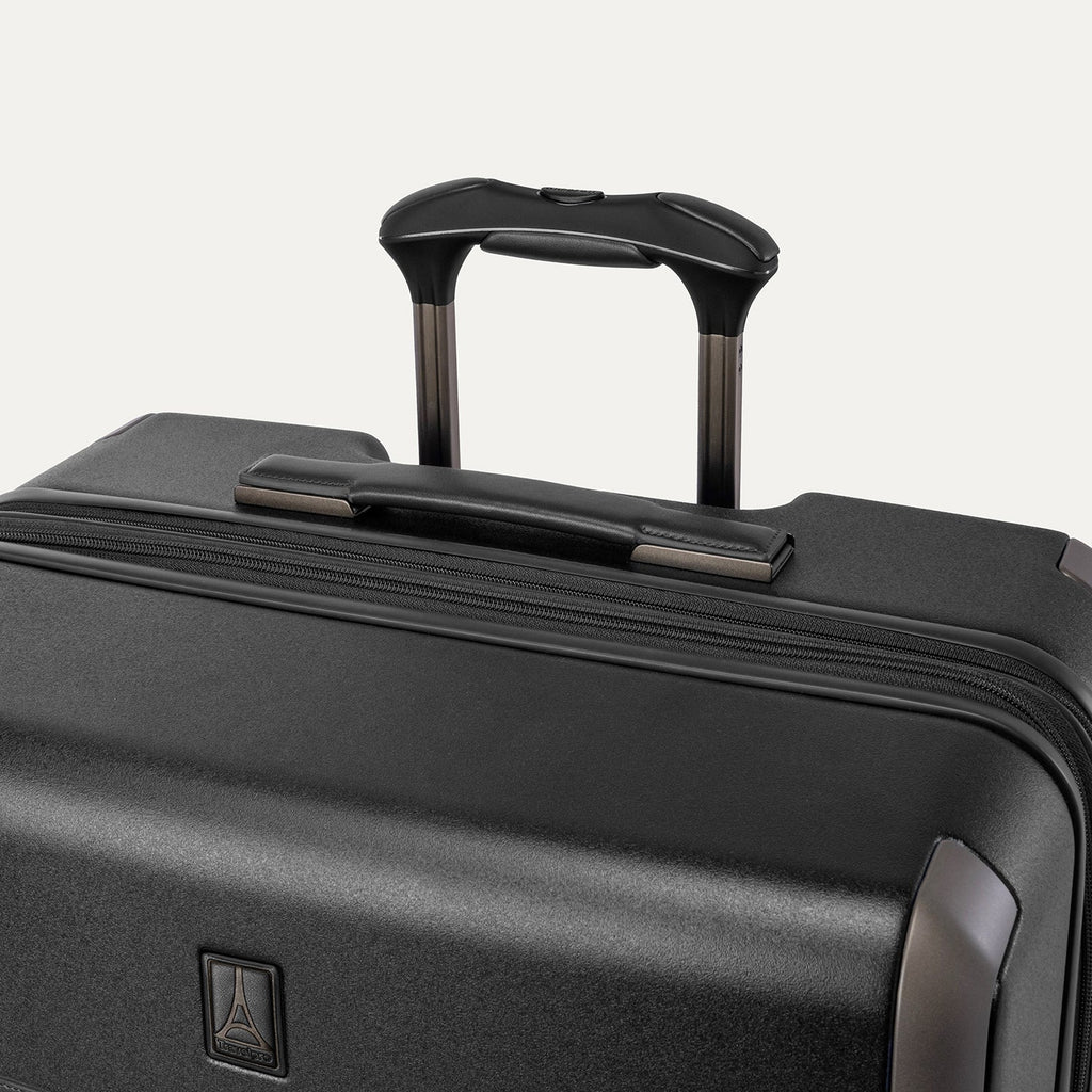 Close-up of the leather-wrapped top handle and PowerScope Lite extension handle on the Travelpro Platinum Reserve Large Check-In Hardside Spinner in Black Dust