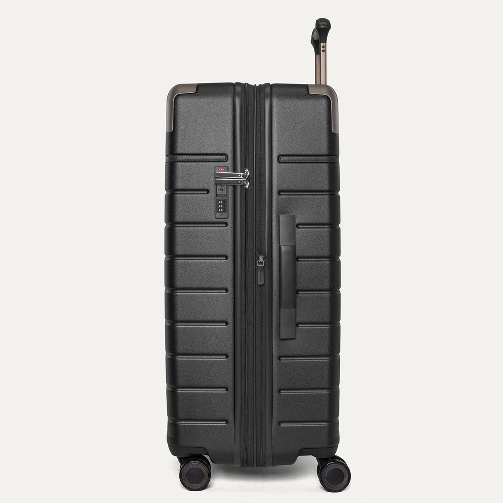 Side profile of the Travelpro Platinum Reserve Large Check-In Hardside Spinner in Black Dust