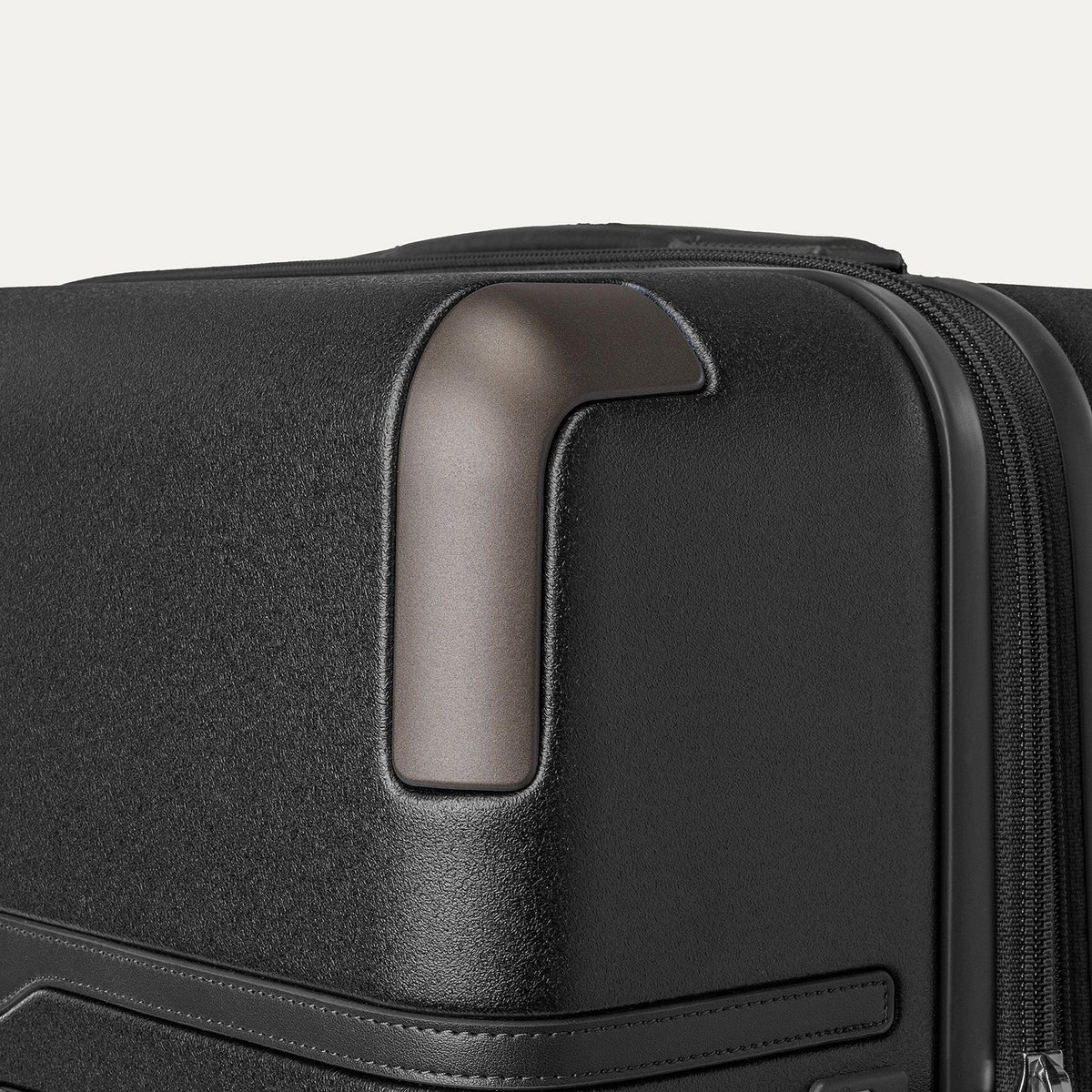 Close-up of the zinc corner armour on the Travelpro Platinum Reserve Large Check-In Hardside Spinner in Black Dust