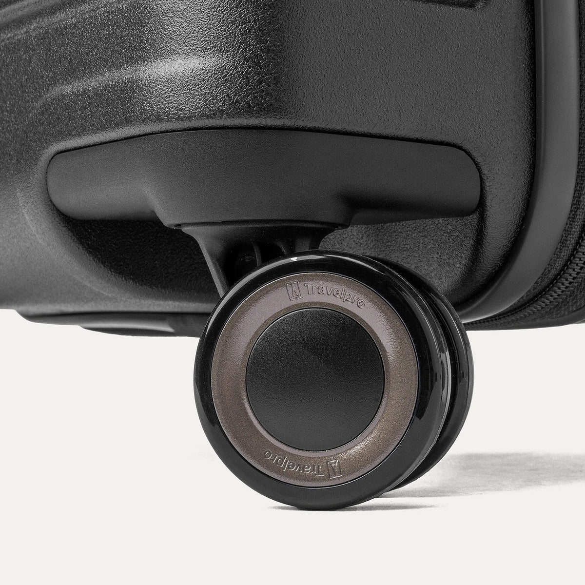 Close-up of a MagnaTrac self-aligning spinner wheel on the Travelpro Platinum Reserve Large Check-In Hardside Spinner in Black Dust