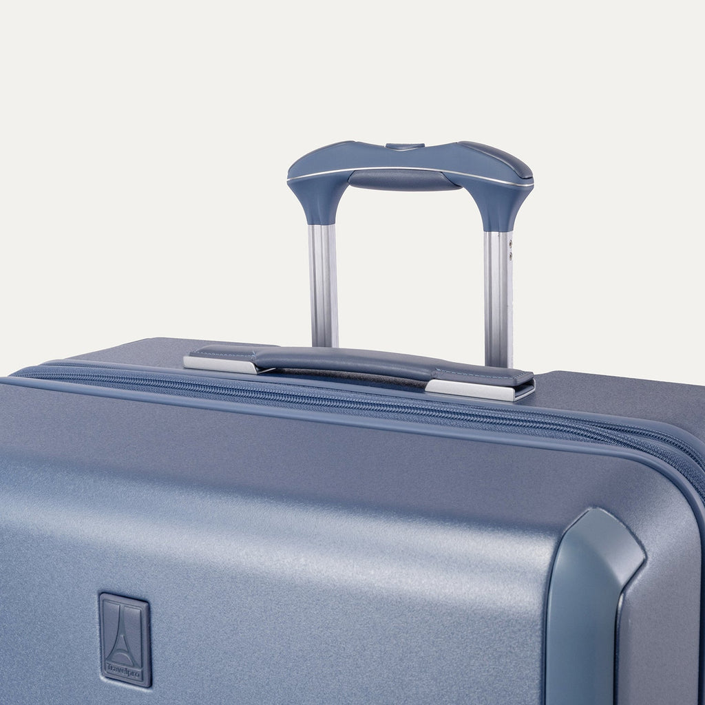 Close-up of the leather-wrapped top handle and PowerScope Lite extension handle on the Travelpro Platinum Reserve Large Check-In Hardside Spinner in Steel Blue