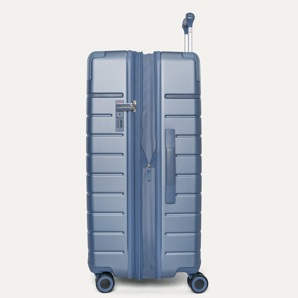Side profile of the Travelpro Platinum Reserve Large Check-In Hardside Spinner in Steel Blue, expanded for extra packing space