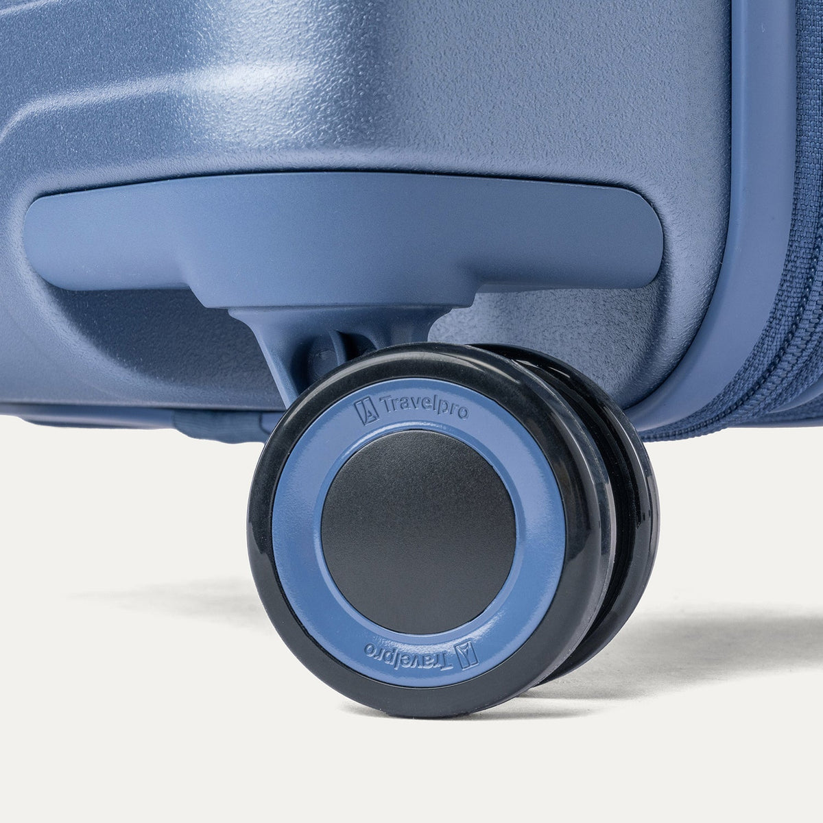 Close-up of a MagnaTrac self-aligning spinner wheel on the Travelpro Platinum Reserve Large Check-In Hardside Spinner in Steel Blue