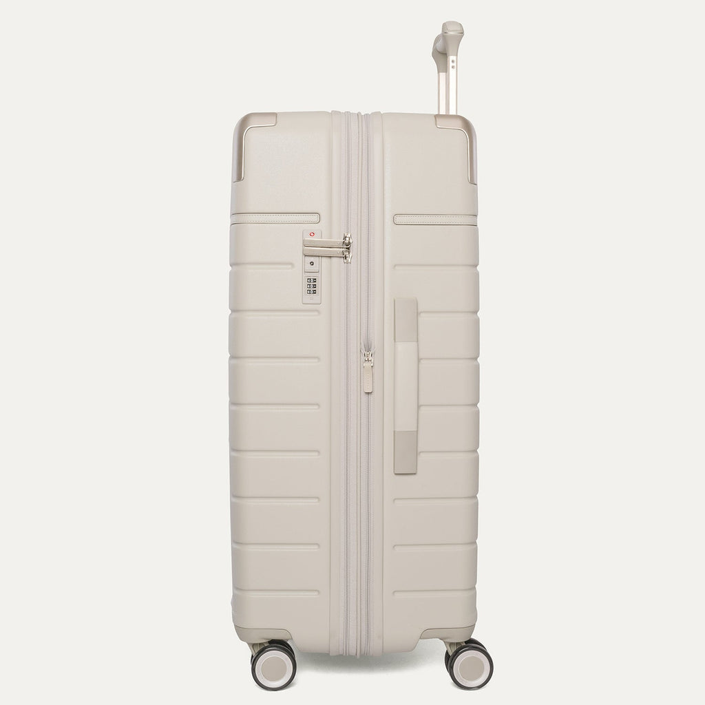 Side profile of the Travelpro Platinum Reserve Large Check-In Hardside Spinner in Sandstone