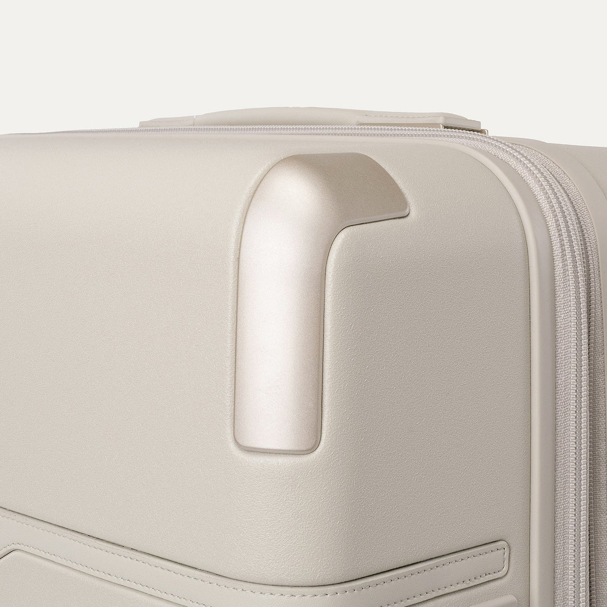 Close-up of the zinc corner armour on the Travelpro Platinum Reserve Large Check-In Hardside Spinner in Sandstone