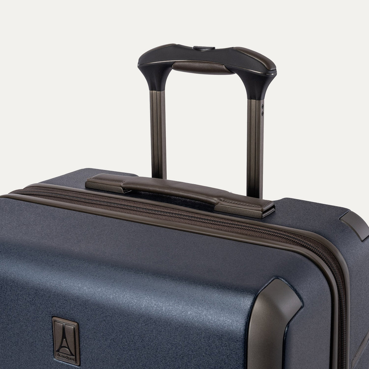 Close-up of the leather-wrapped top handle and PowerScope Lite extension handle on the Travelpro Platinum Reserve Large Check-In Hardside Spinner in Midnight Trail