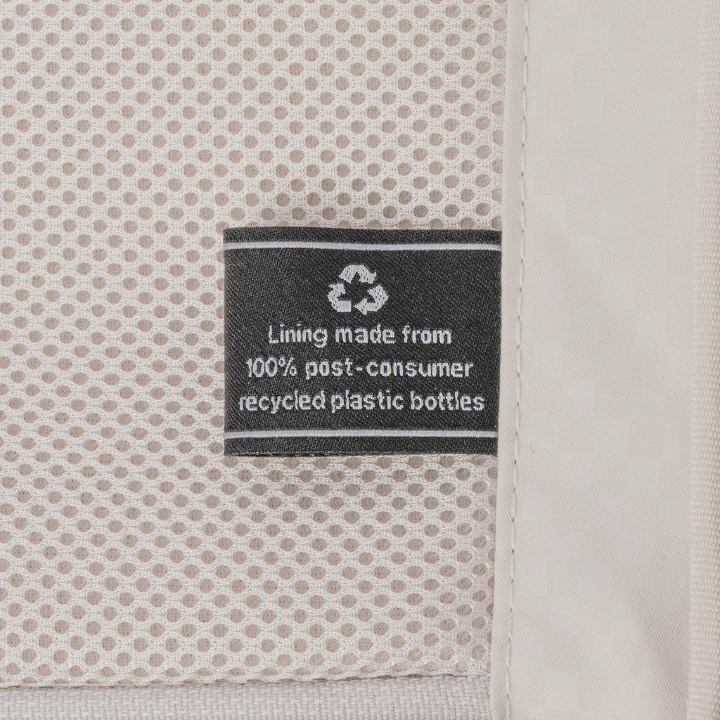 ECOFAB lining label inside the Travelpro Platinum Reserve Large Check-In Hardside Spinner in Midnight Trail, made from 100% post-consumer recycled plastic bottles