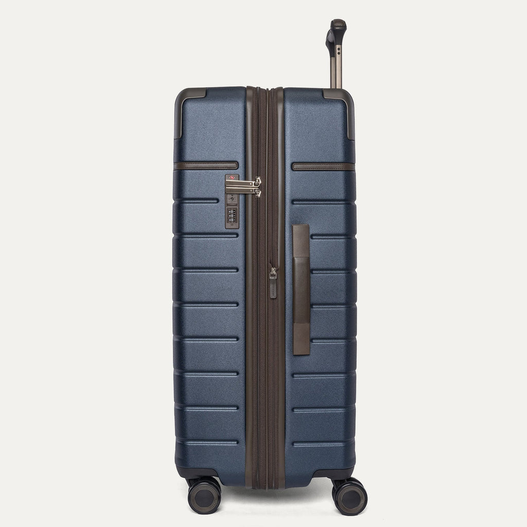 Side profile of the Travelpro Platinum Reserve Large Check-In Hardside Spinner in Midnight Trail