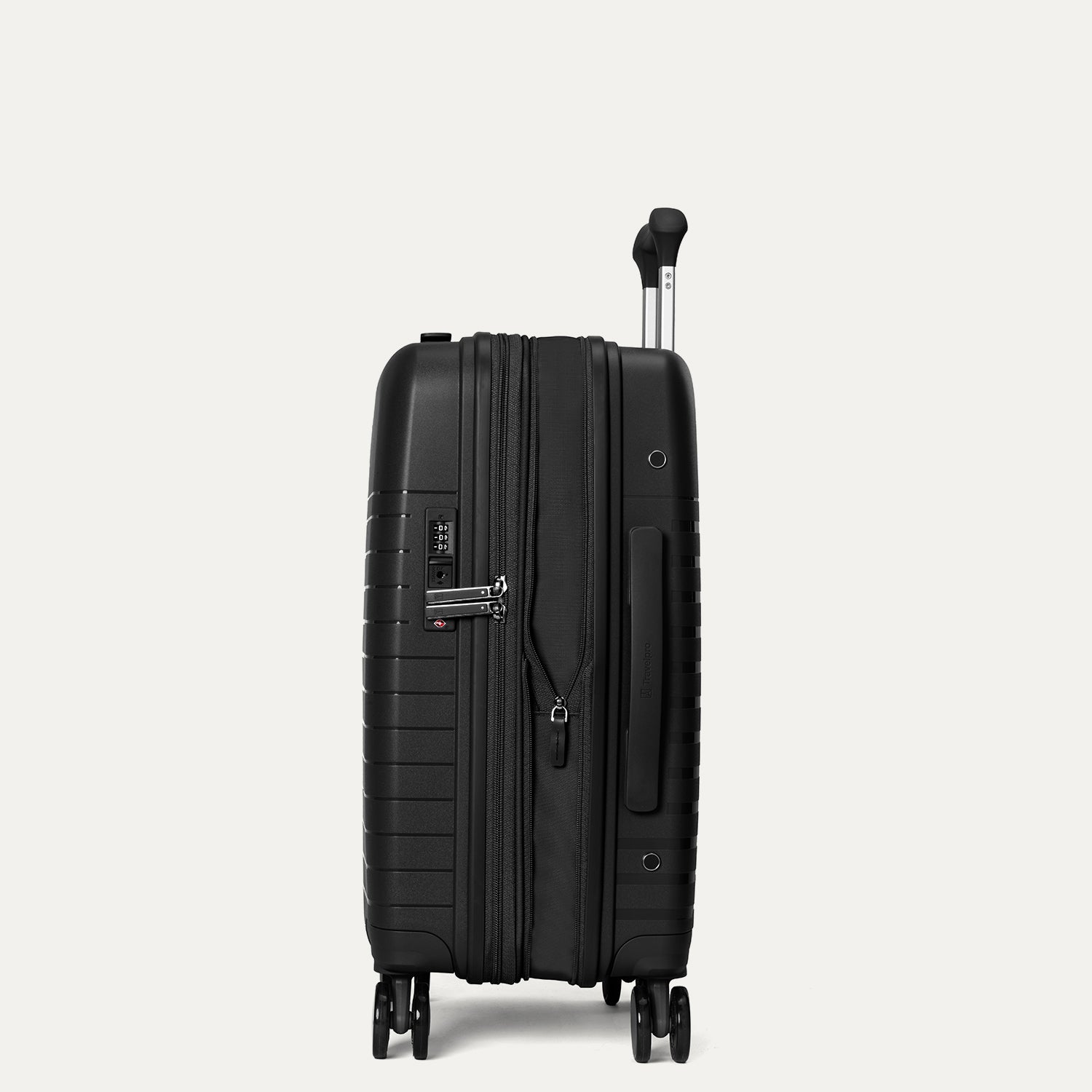 Valise noire à roulettes sur fond gris clair