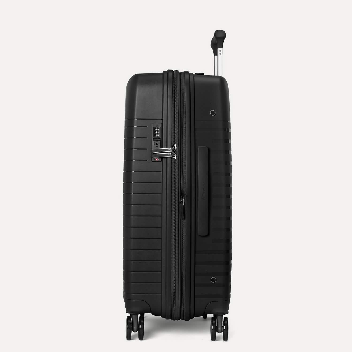 Valise noire à roulettes et poignée sur fond gris clair