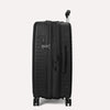 Valise noire à roulettes sur fond gris clair