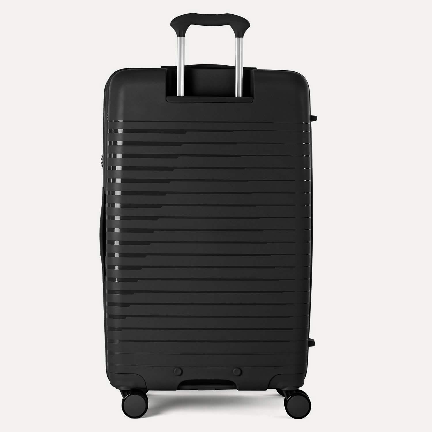 Valise noire à texture nervurée sur fond gris clair
