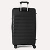 Valise noire à texture nervurée sur fond gris clair