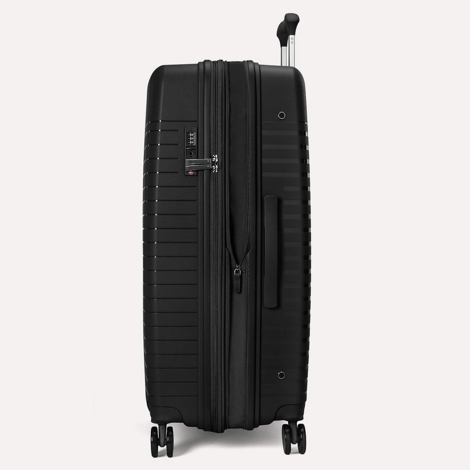 Valise noire à roulettes sur fond gris clair