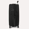 Valise noire à roulettes sur fond gris clair