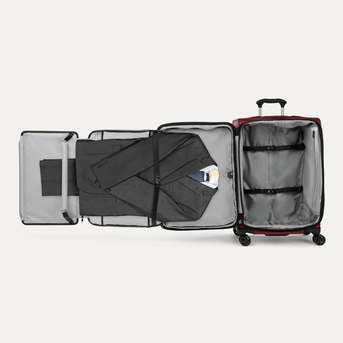 Open red suitcase with fold-out suiter on a white background