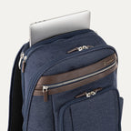 True navy backpack with laptop visibly stored in the dedicated sleeve compartment.
