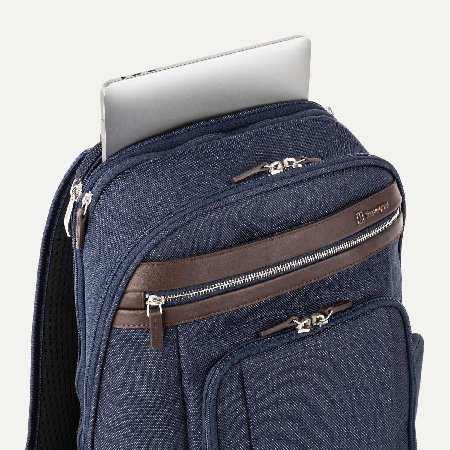 True navy backpack with laptop visibly stored in the dedicated sleeve compartment.
