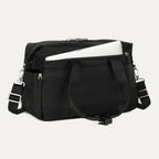 Black tote with a laptop in the padded sleeve compartment on a white background 