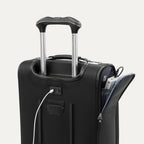Close-up of black suitcase with extended handle and visible USB charging cable, on white background