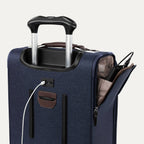 Close-up of blue suitcase with extended handle and visible USB charging cable, on white background
