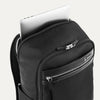 Black backpack with laptop visibly stored in the dedicated sleeve compartment.
