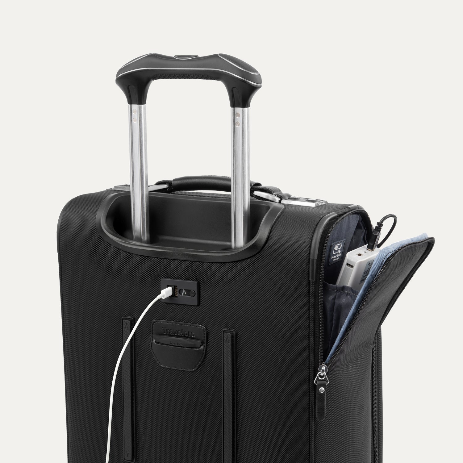 Close-up of black suitcase with extended handle and visible USB charging cable, on white background