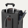 Close-up of gray suitcase with extended handle and visible USB charging cable, on white background