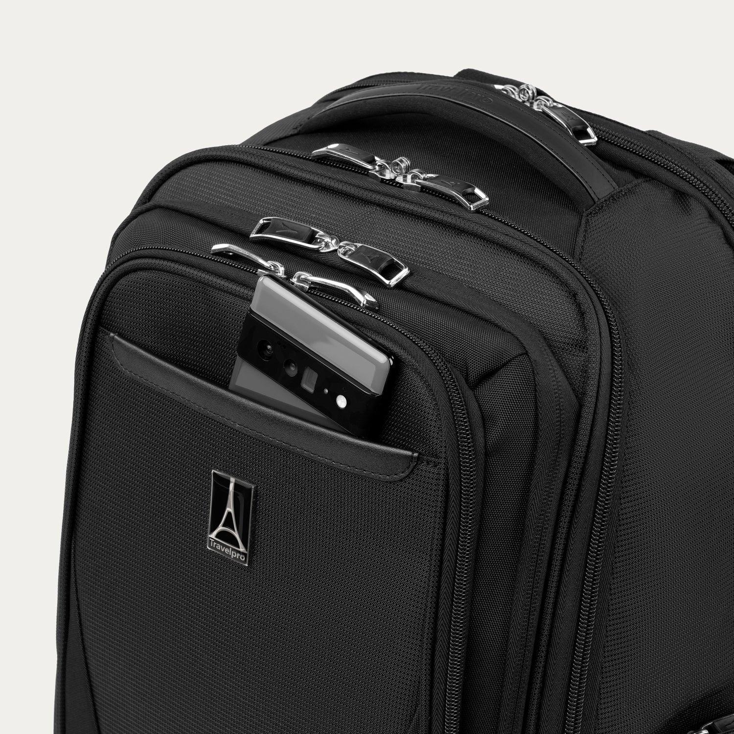 Black backpack with phone in QuickSlip pocket on a white background