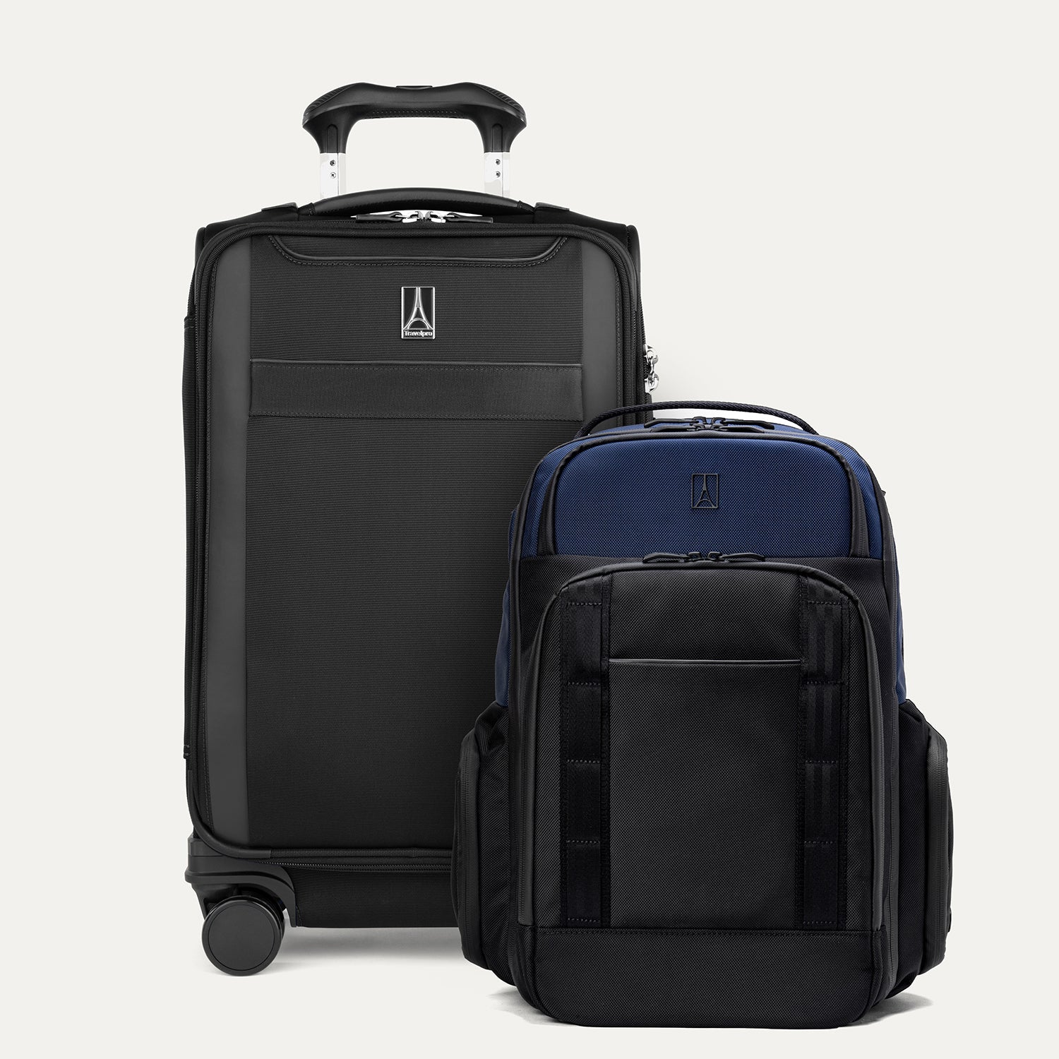 A set of two pieces of luggage, a large aviator navy expandable laptop backpack and a smaller black carry-on spinner on a white background