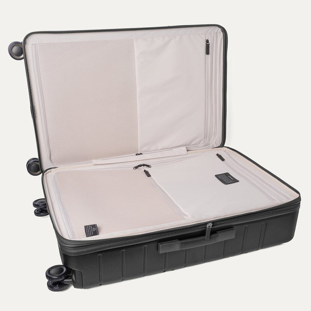 Open interior of the Large Check-In from the Travelpro Platinum Reserve Compact Carry-On / Large Check-In Hardside Set in Black Dust showing the zippered divider panel