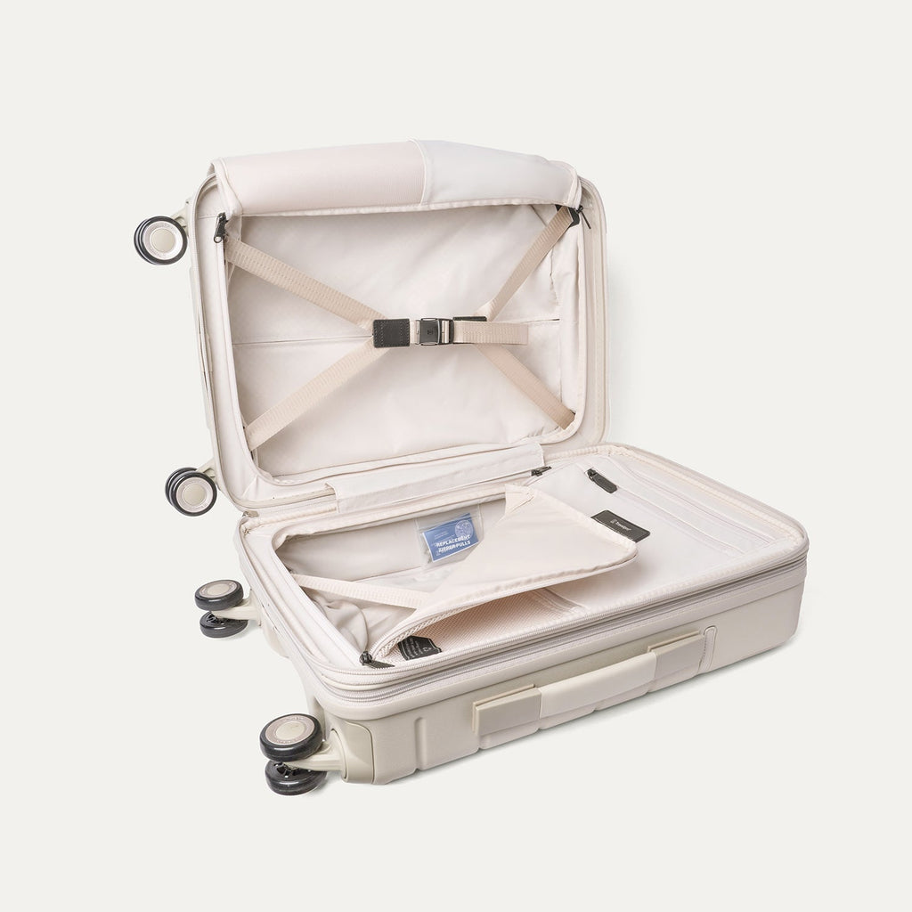 Open interior of the Compact Carry-On from the Travelpro Platinum Reserve Compact Carry-On / Medium Check-In Hardside Set in Sandstone with hold-down straps