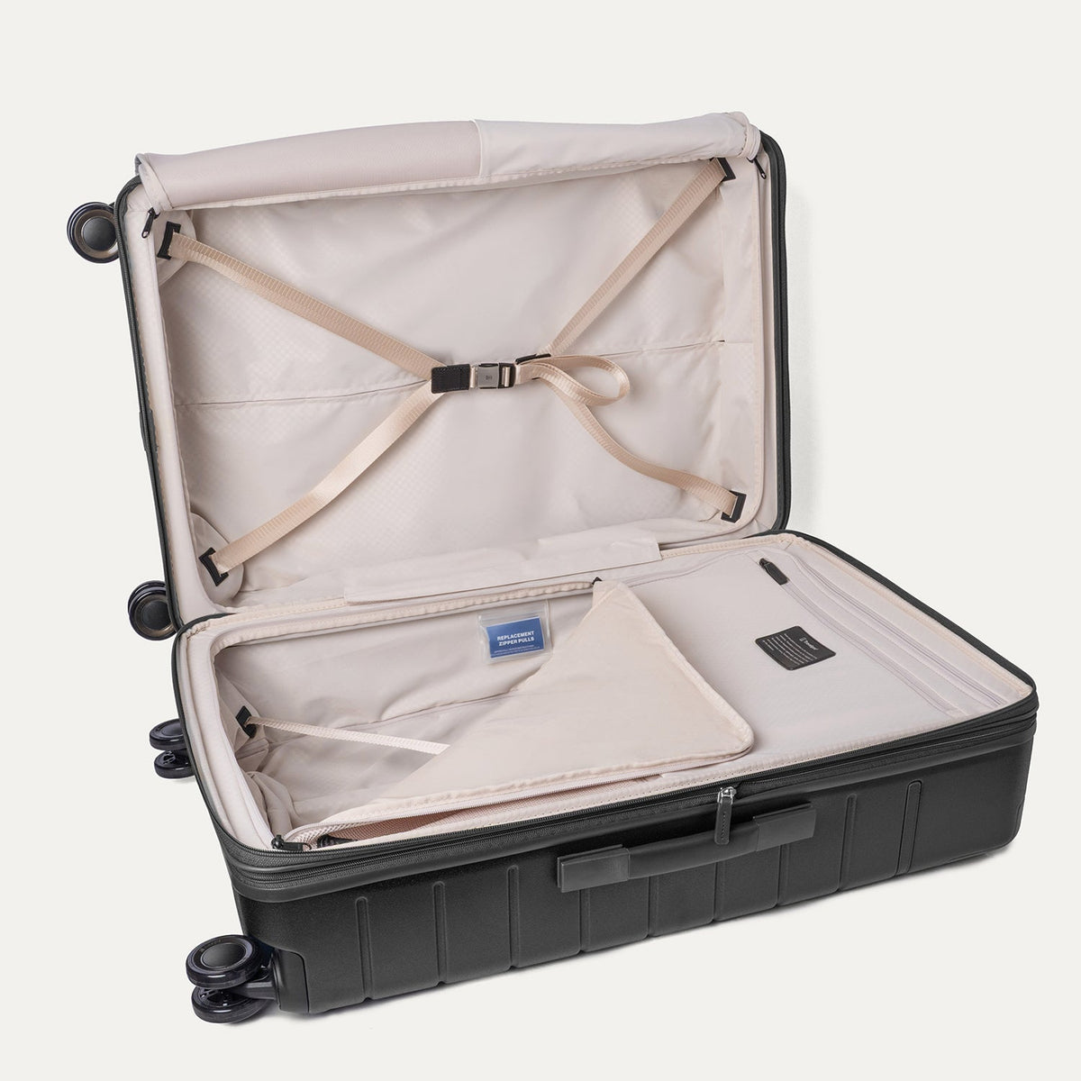 Open interior of the Large Check-In from the Travelpro Platinum Reserve Compact Carry-On / Medium / Large Hardside Set in Black Dust with hold-down straps