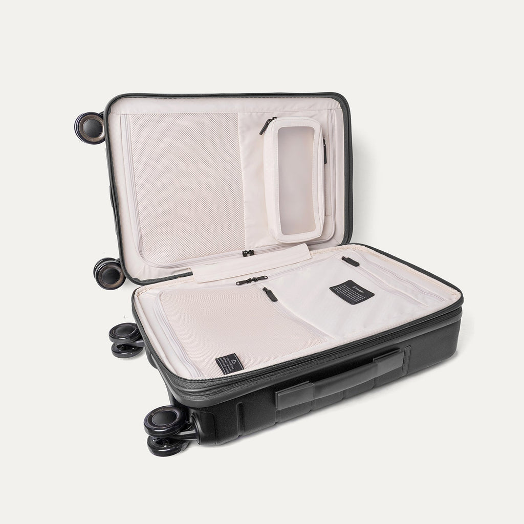 Open interior of the Compact Carry-On from the Travelpro Platinum Reserve Compact Carry-On / Medium / Large Hardside Set in Black Dust showing the zippered divider panel