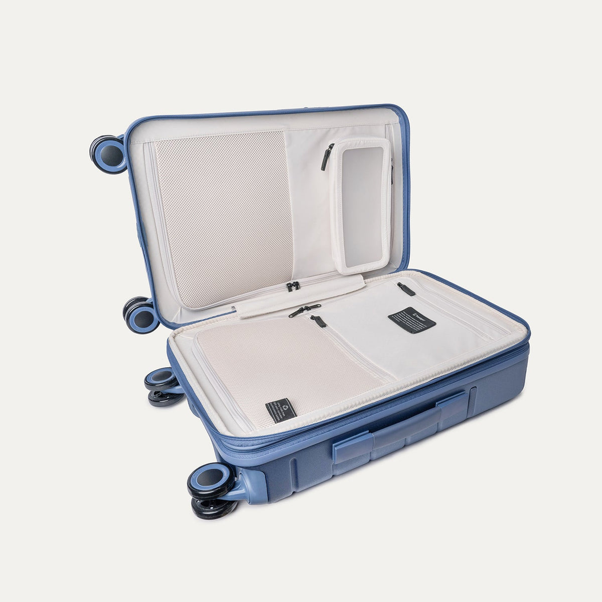 Open interior of the Compact Carry-On from the Travelpro Platinum Reserve Compact Carry-On / Medium / Large Hardside Set in Steel Blue showing the zippered divider panel