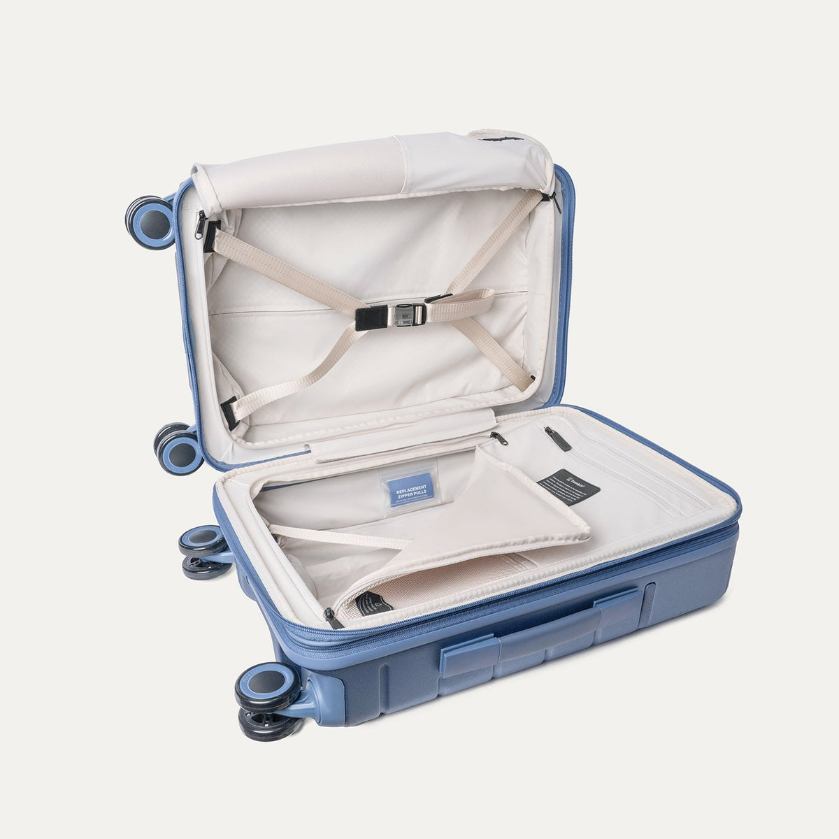 Open interior of the Compact Carry-On from the Travelpro Platinum Reserve Compact Carry-On / Medium / Large Hardside Set in Steel Blue with hold-down straps