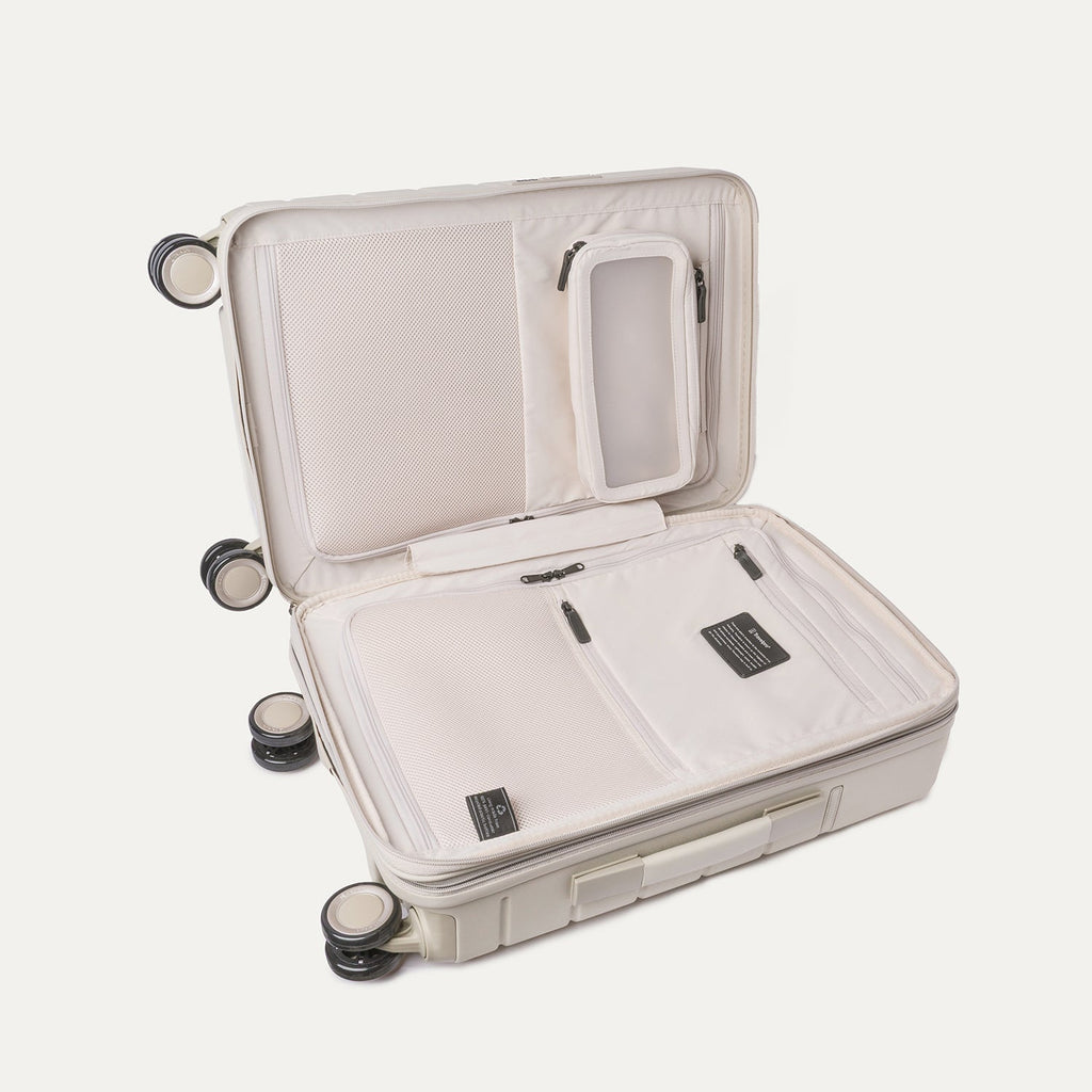 Open interior of the Compact Carry-On from the Travelpro Platinum Reserve Compact Carry-On / Medium / Large Hardside Set in Sandstone showing the zippered divider panel
