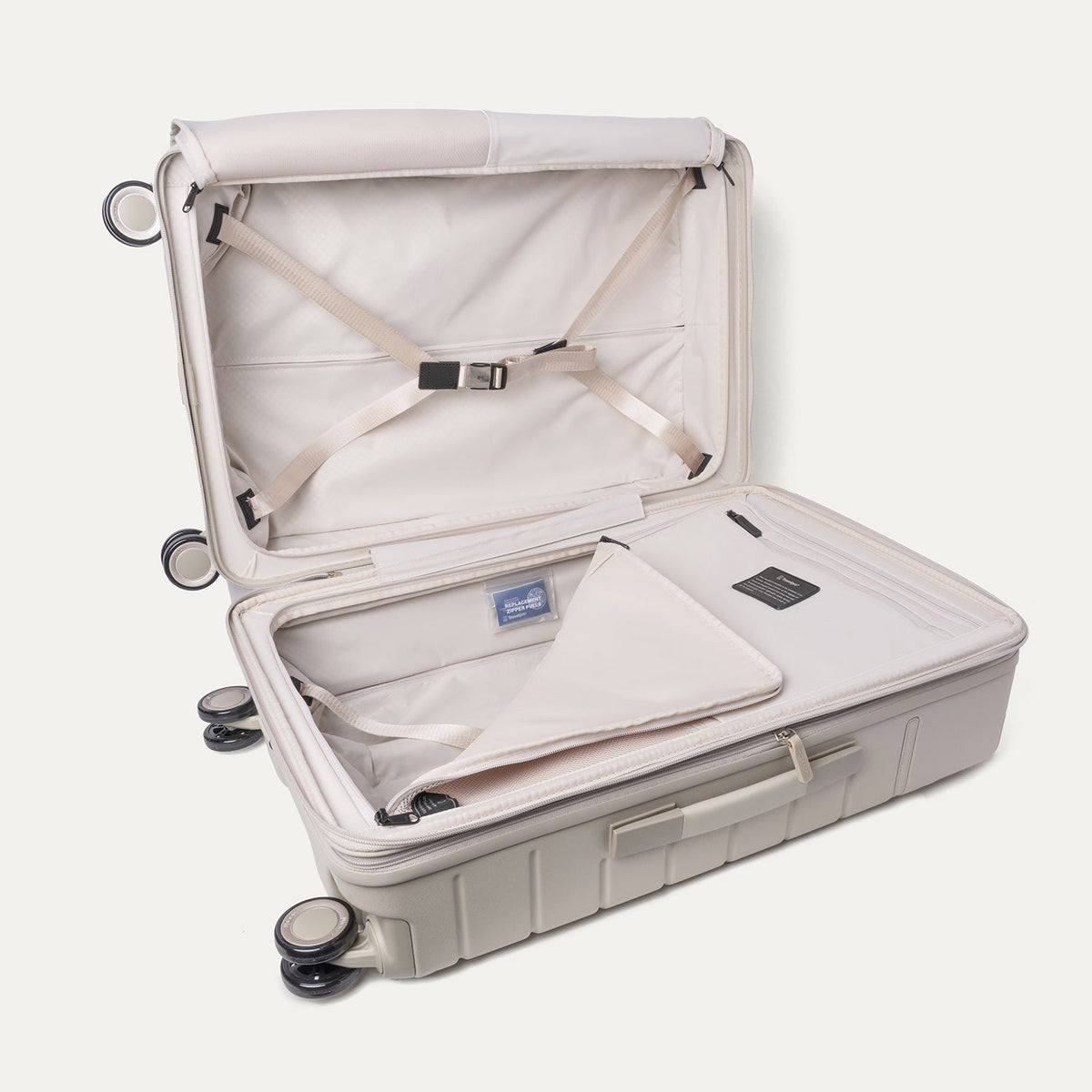 Open interior of the Medium Check-In from the Travelpro Platinum Reserve Compact Carry-On / Medium / Large Hardside Set in Sandstone with hold-down straps