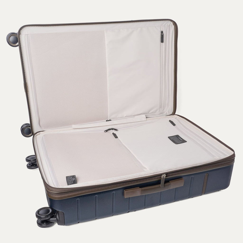 Open interior of the Large Check-In from the Travelpro Platinum Reserve Compact Carry-On / Medium / Large Hardside Set in Midnight Trail showing the zippered divider panel