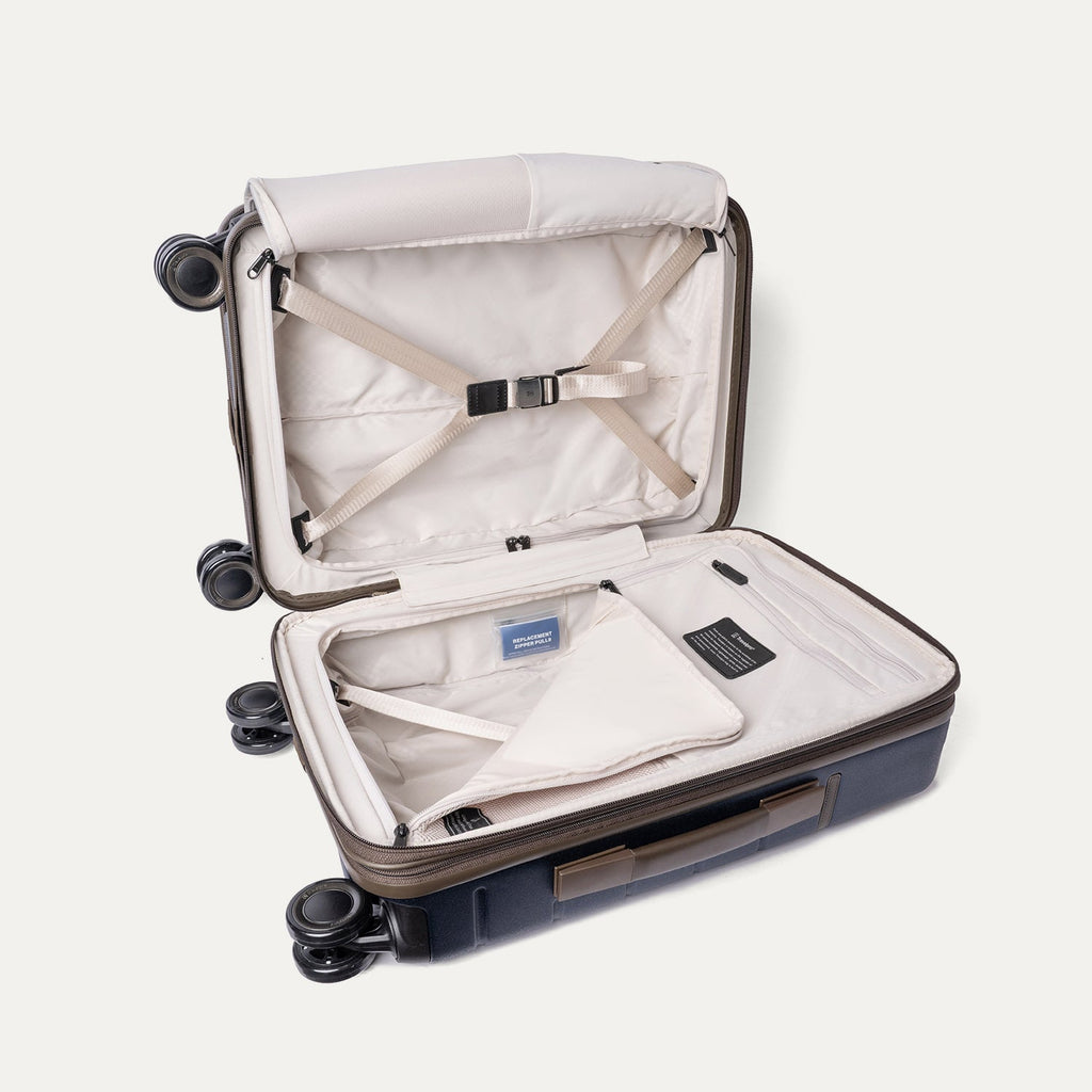 Open interior of the Compact Carry-On from the Travelpro Platinum Reserve Compact Carry-On / Medium / Large Hardside Set in Midnight Trail with hold-down straps