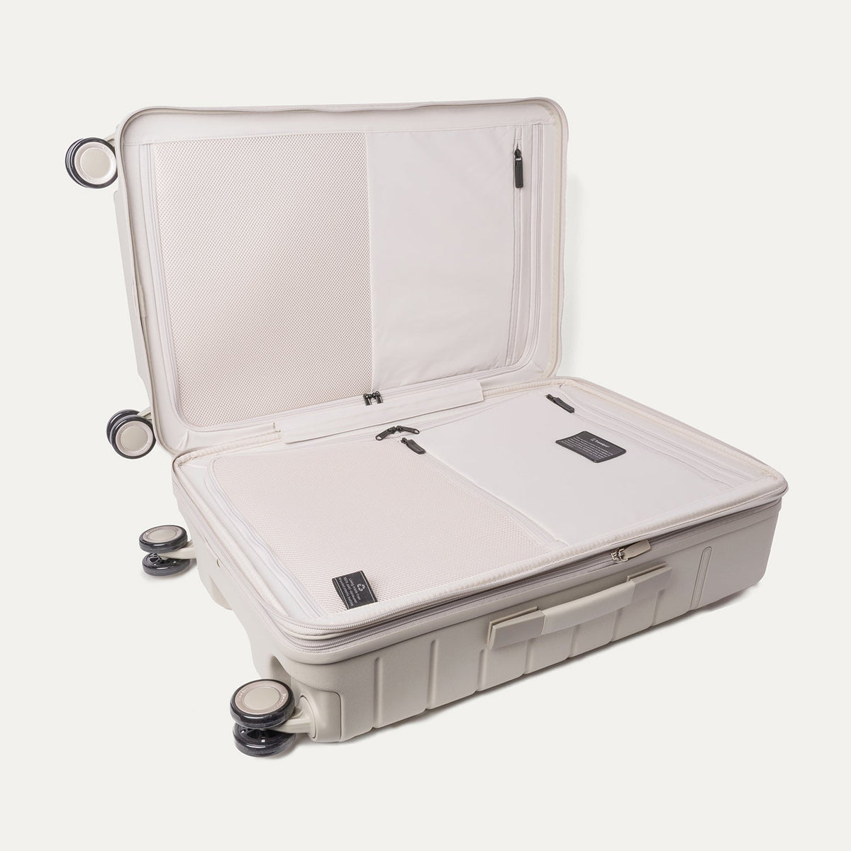 Open interior of the Medium Check-In from the Travelpro Platinum Reserve Medium / Large Check-In Hardside Set in Sandstone showing the zippered divider panel