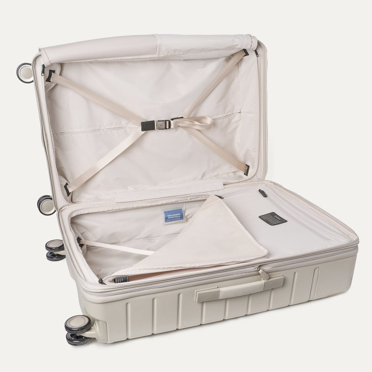 Open interior of the Large Check-In from the Travelpro Platinum Reserve Medium / Large Check-In Hardside Set in Sandstone with hold-down straps