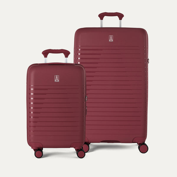 Two red suitcases with a visible brand logo on a light gray background